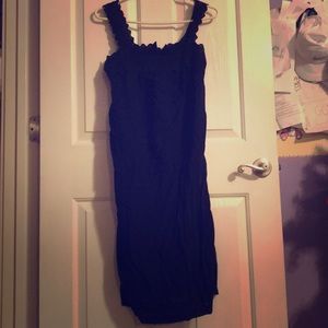 Mid length black loose fitting dress.